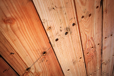 Brown wooden unpainted texture background with knots. Detail. Shallow DOFの写真素材