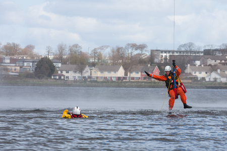 GALWAY, IRELAND - APRIL 12: Irish Coast Guard crew display a water rescue training over Lough Atalia as part of the anual Galway Watersports Show, on April 12, 2015 in Galway, Ireland.のeditorial素材