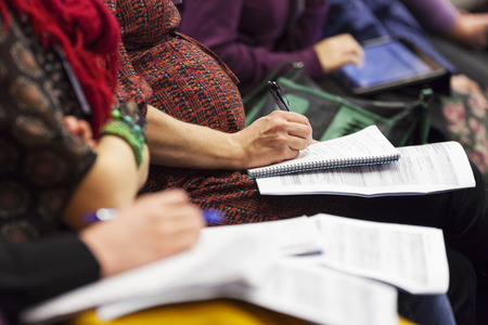 Close-up of Hands holding pens and making notes at the conferenceの写真素材