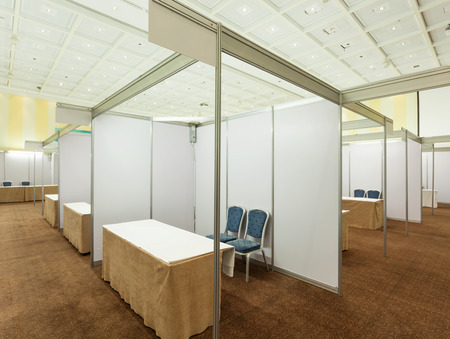 Trade show interior with booth and tablesの写真素材