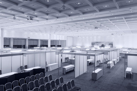Trade show interior with booth and tablesの写真素材
