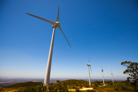 Wind Turbine power generators on the mountain during sunny day