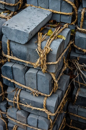 Bricks are hauled into the hutongs and tied together with rope as they wait to build.の写真素材