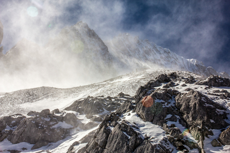 The Snow blows over the top of the peak of the Jade Dragon Snow Mountain.の写真素材
