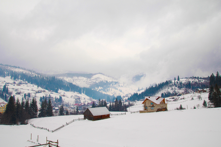 Mountain house covered with fresh snow in the Carpathian mountainsの写真素材