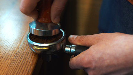Espresso tamping.Barista is preparing ground for espresso machine,coffee concept.の写真素材