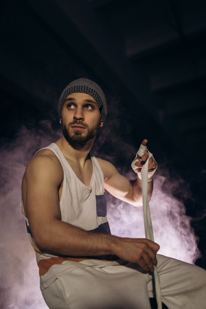 Sports boxer man pulls on the hand wrist wraps.の写真素材