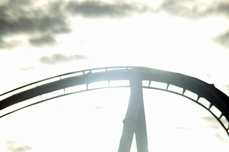 Black and white hyper roller coaster rail with the sun behindの写真素材