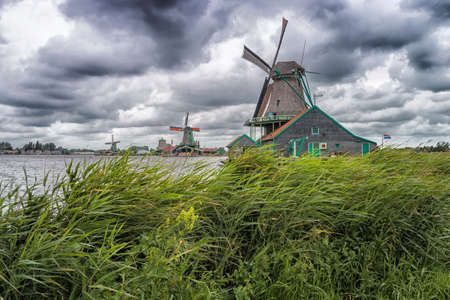 A Dutch mill in the west of the Netherlands. The photo is make in the Zaanse Schans in the west of the Netherlands.の写真素材