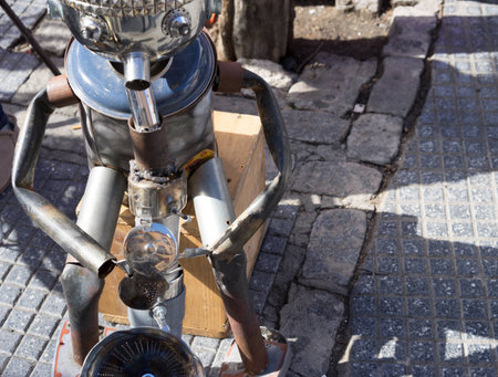 Man made of tin playing the saxaphone on the streetの写真素材