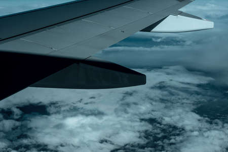 airplane wing with clouds with blue skyの写真素材