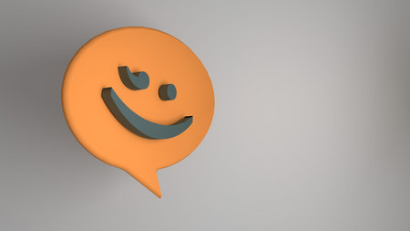 3D rendering of an orange emoticon in a speech bubble on gray backgroundの写真素材