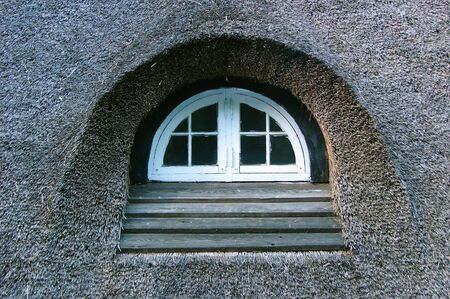                               little window in a roof of strawの写真素材