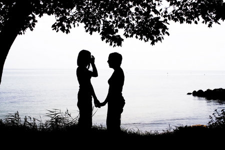 two girls in silhouetteの写真素材