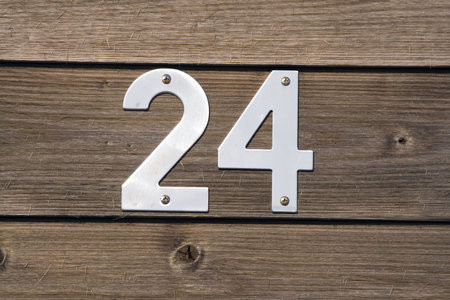 number 24 on a wooden fence