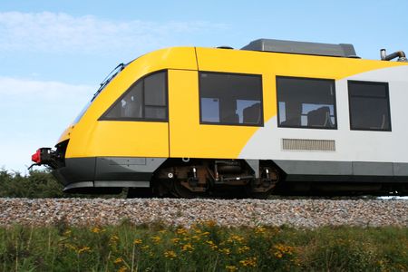 little yellow and grey train in motionの写真素材