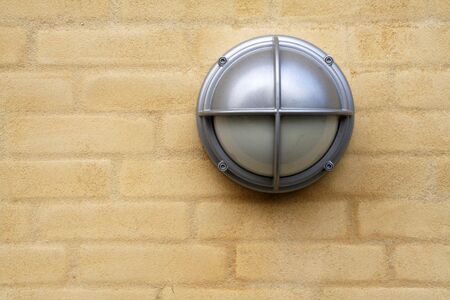 lamp on a yellow brickwallの写真素材