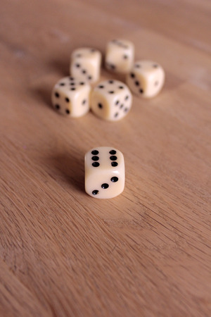 six dices on a wooden tableの写真素材