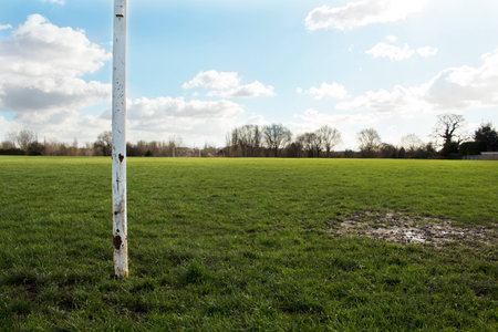 A Close Up Of A Goal Post On A Field In The Sun With Blue Sky And Cloudsの写真素材