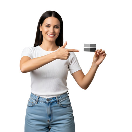Smiling woman in casual clothing points to a card with gray and black color swatches, isolated on white.の素材