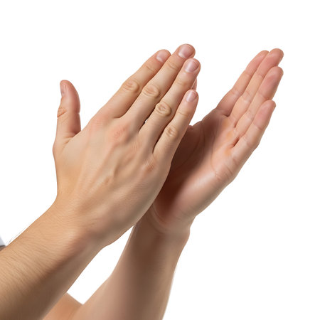 A close-up image of two hands with palms facing each other, isolated on a white background. The hands are positioned in a gentle gesture, as if about to clap or in a prayer-like pose.の素材