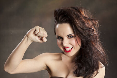 Pretty woman flexing muscleの写真素材