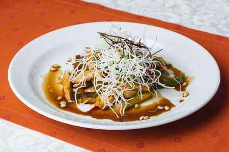 Fried chicken and vegetables with crispy white noodlesの写真素材