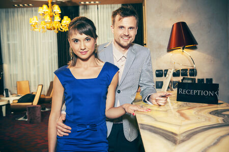 Man and woman checking into a hotelの写真素材