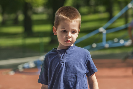 Little boy at the playground looking sadの写真素材
