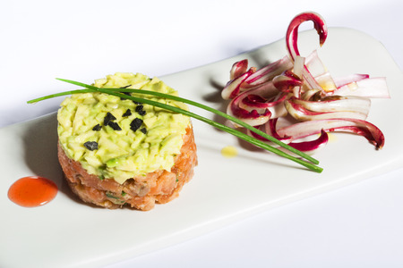 Salmon and avocado tartare with chicoryの写真素材