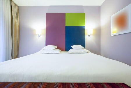 Interior of a colorful hotel bedroomの写真素材