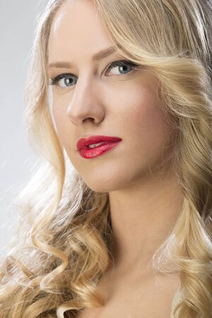 Portrait of a beautiful blond woman with red lipstickの写真素材