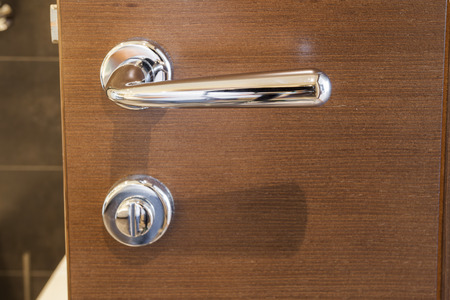 Doorknob and lock on wooden doorの写真素材