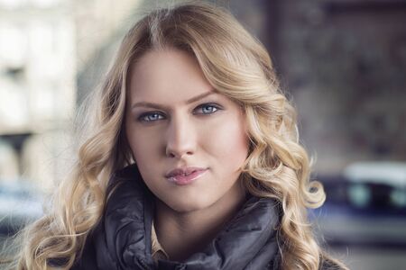 Portrait of a beautiful young woman outdoors on a chilly dayの写真素材