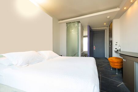 Interior of a double hotel bedroom in the morning sunlightの写真素材