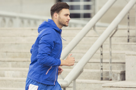 Young man jogging outdoorsの写真素材