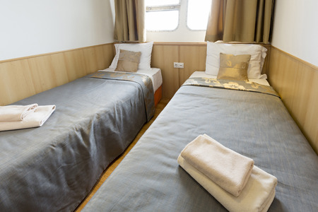 Interior of a cabin bedroom on cruise boat hotelの写真素材