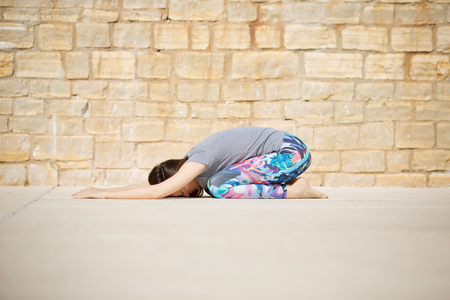 Beautiful young woman working out , doing yoga exerciseの写真素材