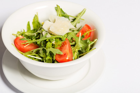 Green salad with arugula, tomatoes and cheeseの写真素材