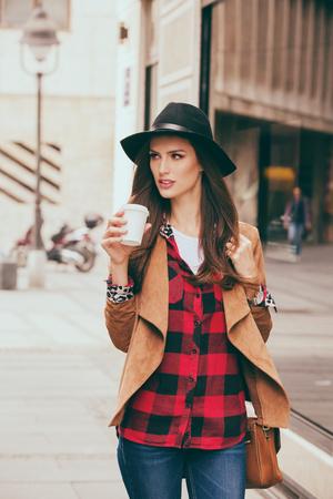 Young woman in a hurry going to workの写真素材