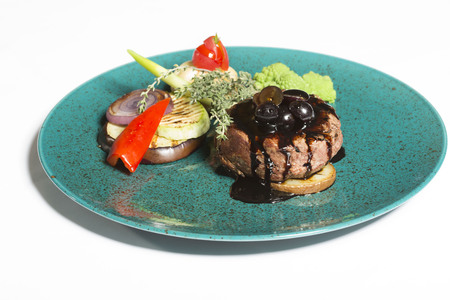 Pork burger served with sauce and grilled vegetablesの写真素材