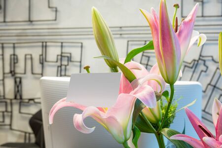 Blank business card in flower bouquetの写真素材