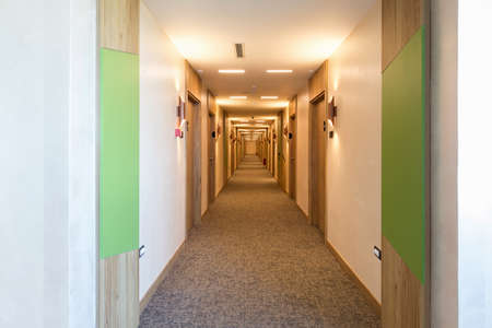 Interior of a long hotel corridor doorwayの写真素材
