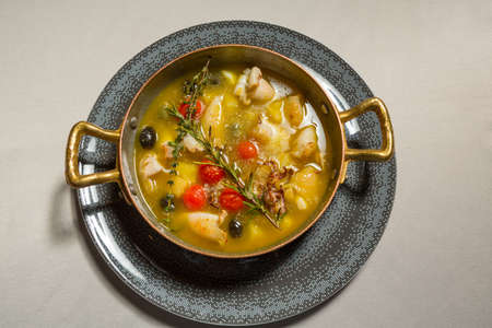 Squid soup with vegetables served in a restaurant, top viewの写真素材