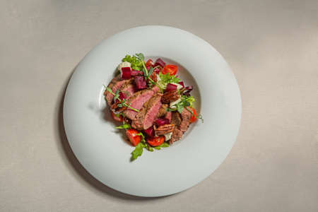 Beef steak salad served in white plateの写真素材