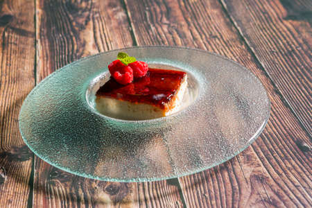 Raspberry tart served on a glass plate