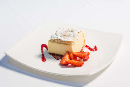 Cream pie served with strawberries