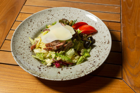 Mixed green salad with beef steakの写真素材