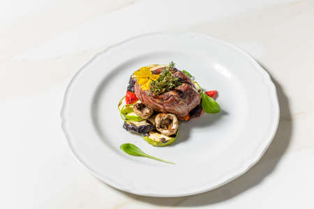 Beef steak served with grilled vegetablesの写真素材