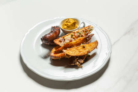 Grilled sausage served with potato and mustard